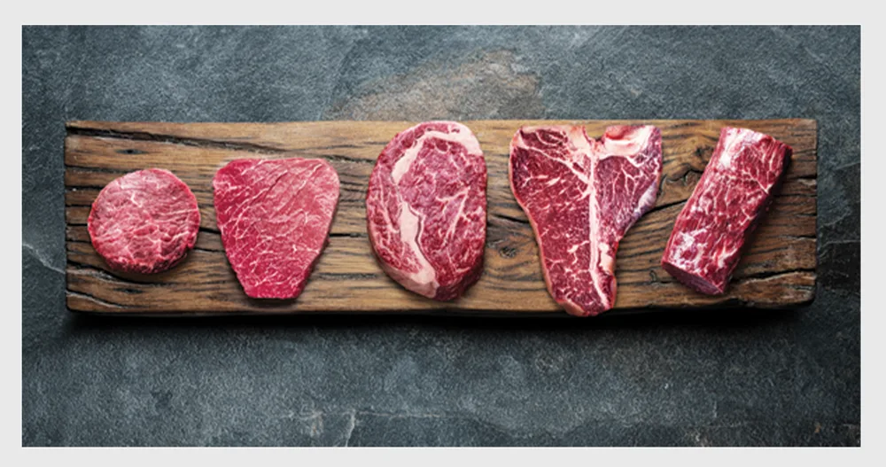 Raw Wagyu steaks on a board