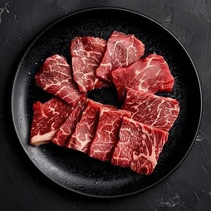 Cubed Wagyu beef on a black plate