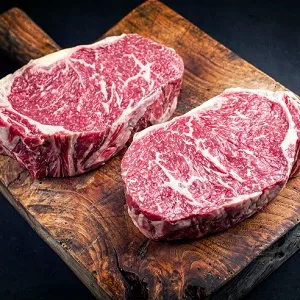 Two raw Wagyu entrecôte steaks on a board